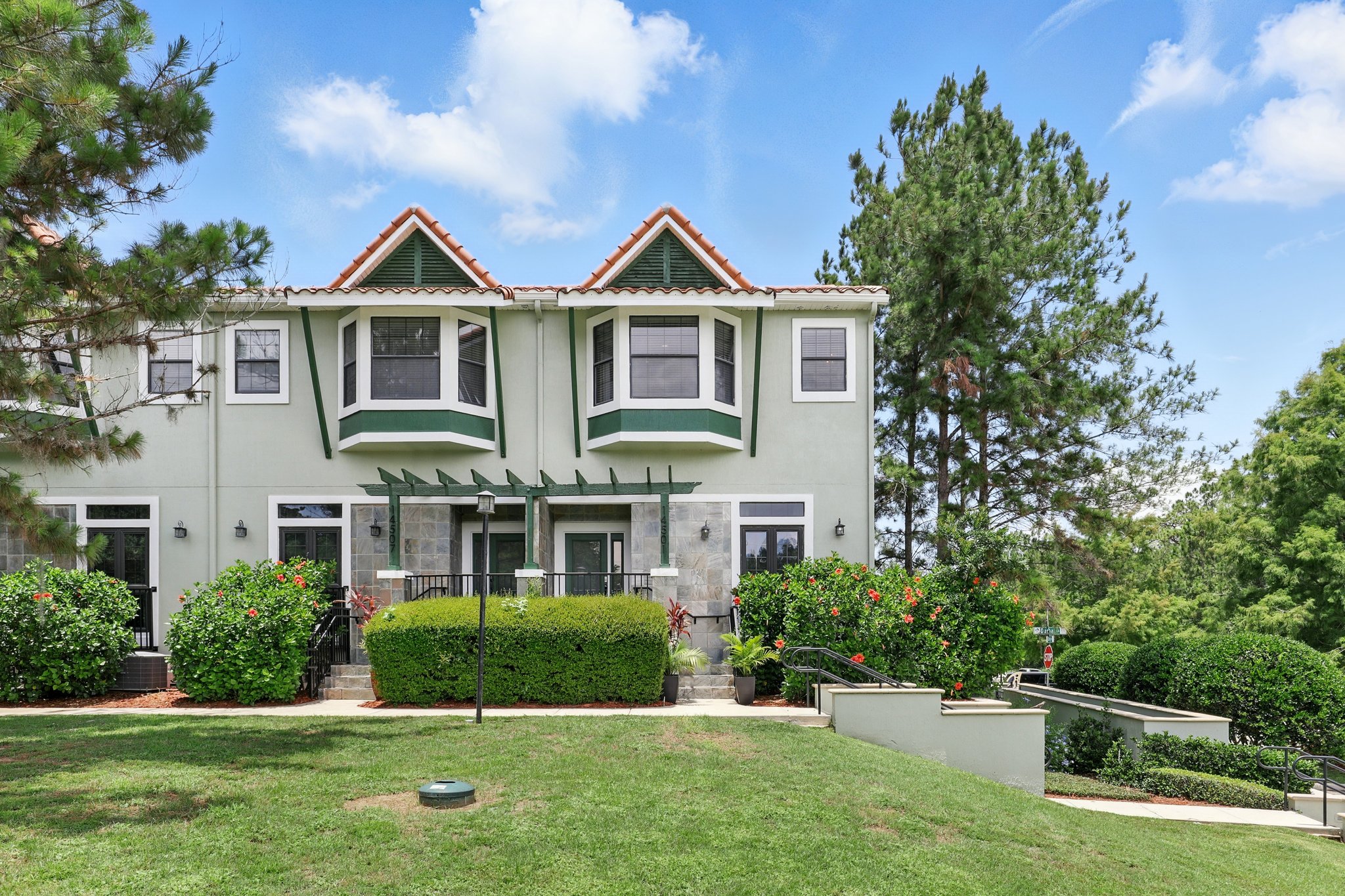 Green front entrance with stone facade