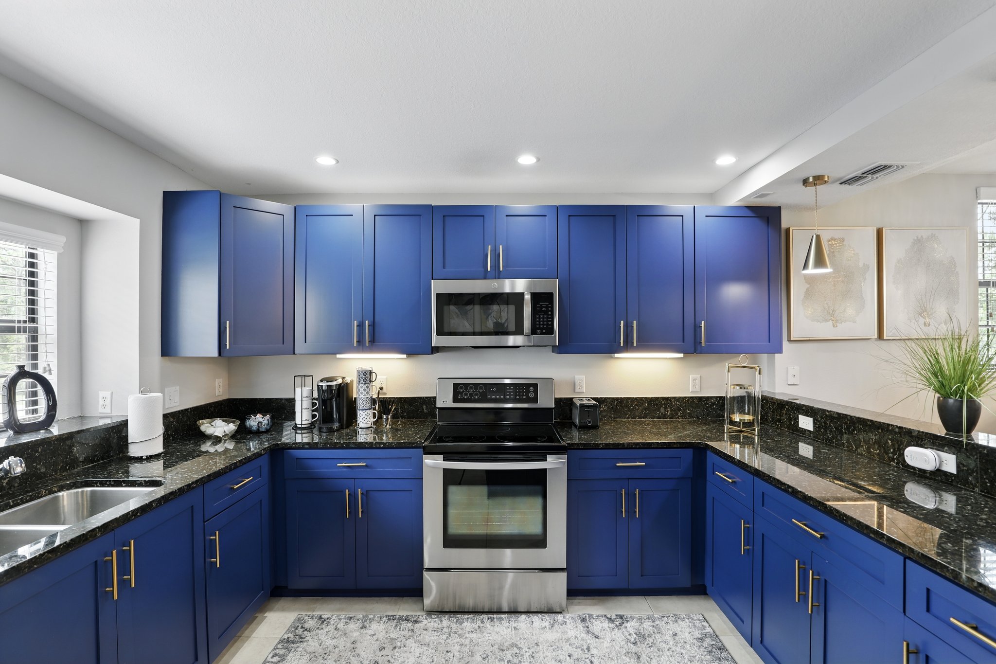 Designer kitchen with blue cabinetry and granite