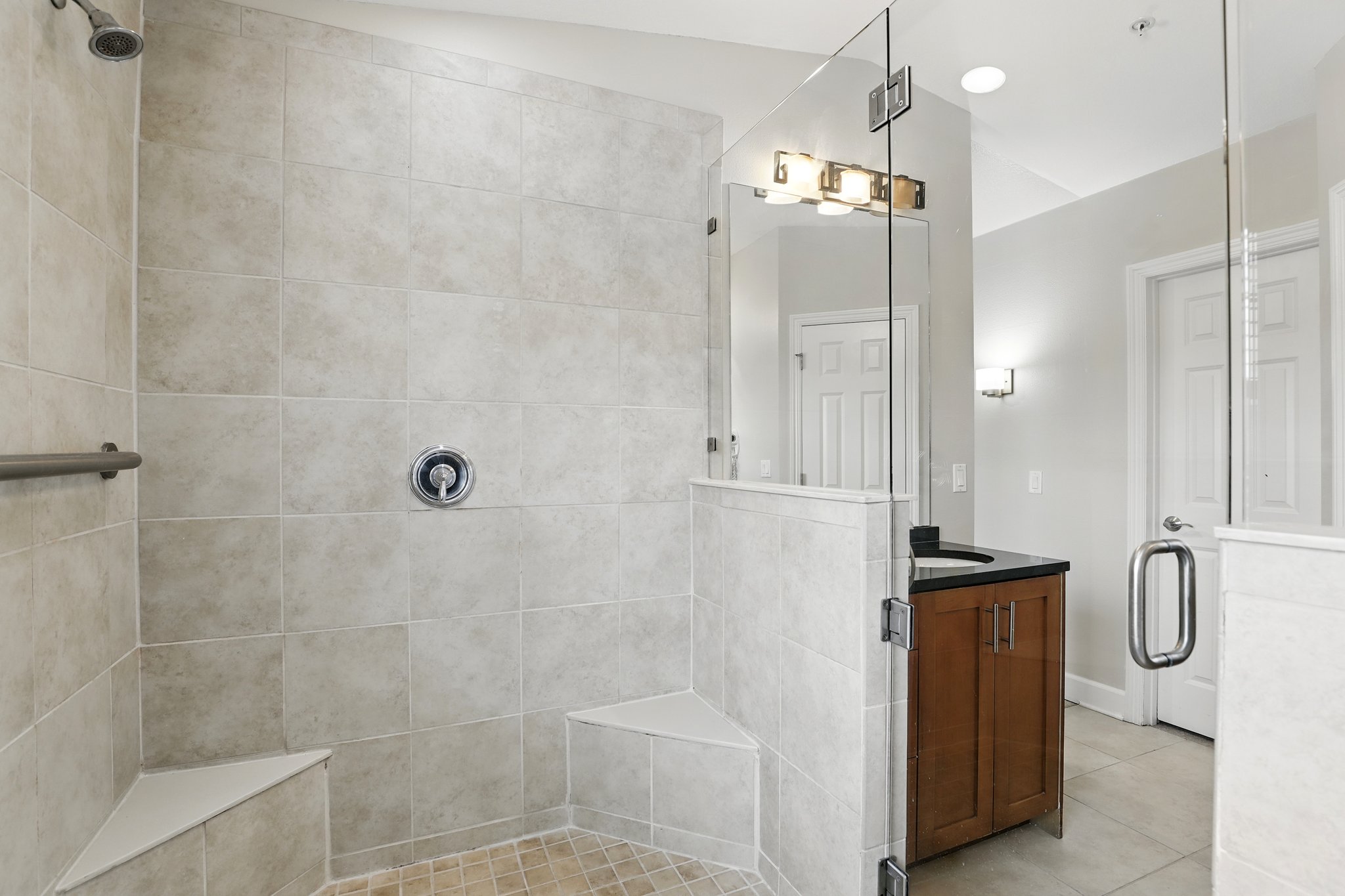 Walk-in master shower with tile bench