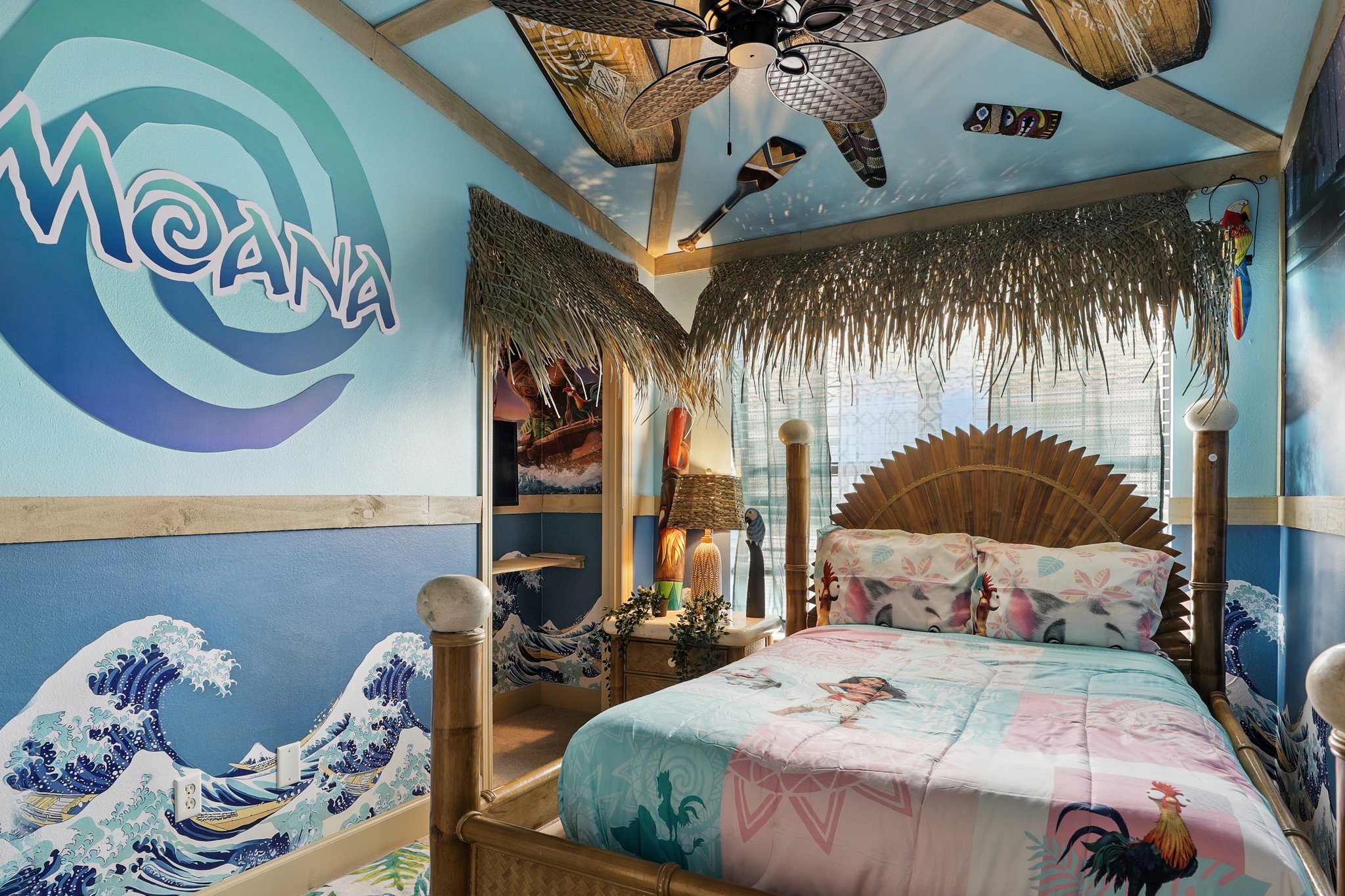 Island-themed bedroom with surfboard and murals