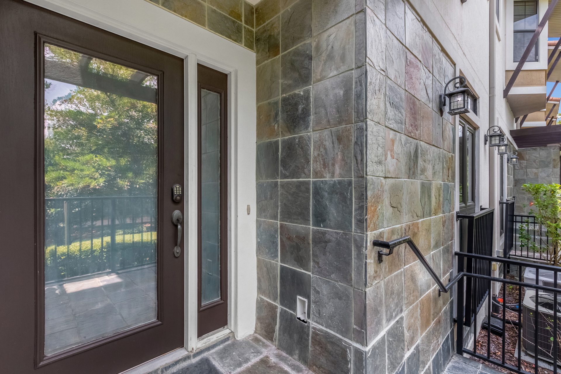 Garden-side entry with slate stone wall and sidelight door