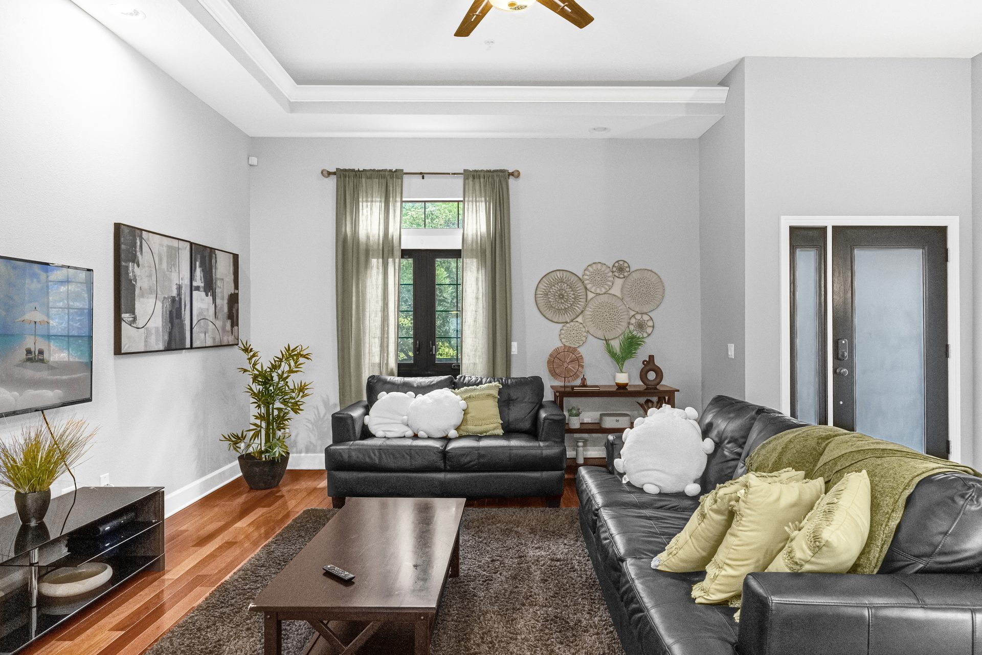 Living room with tray ceiling and tall French doors