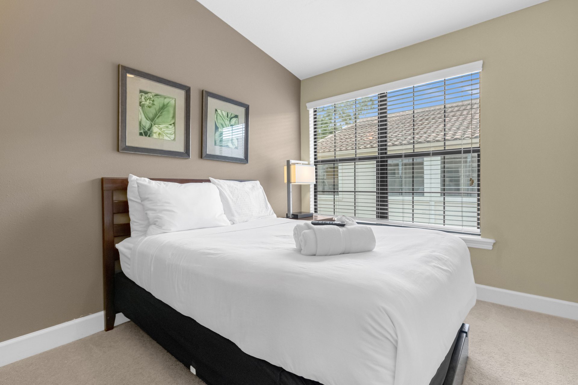 Guest bedroom with botanical prints and window light