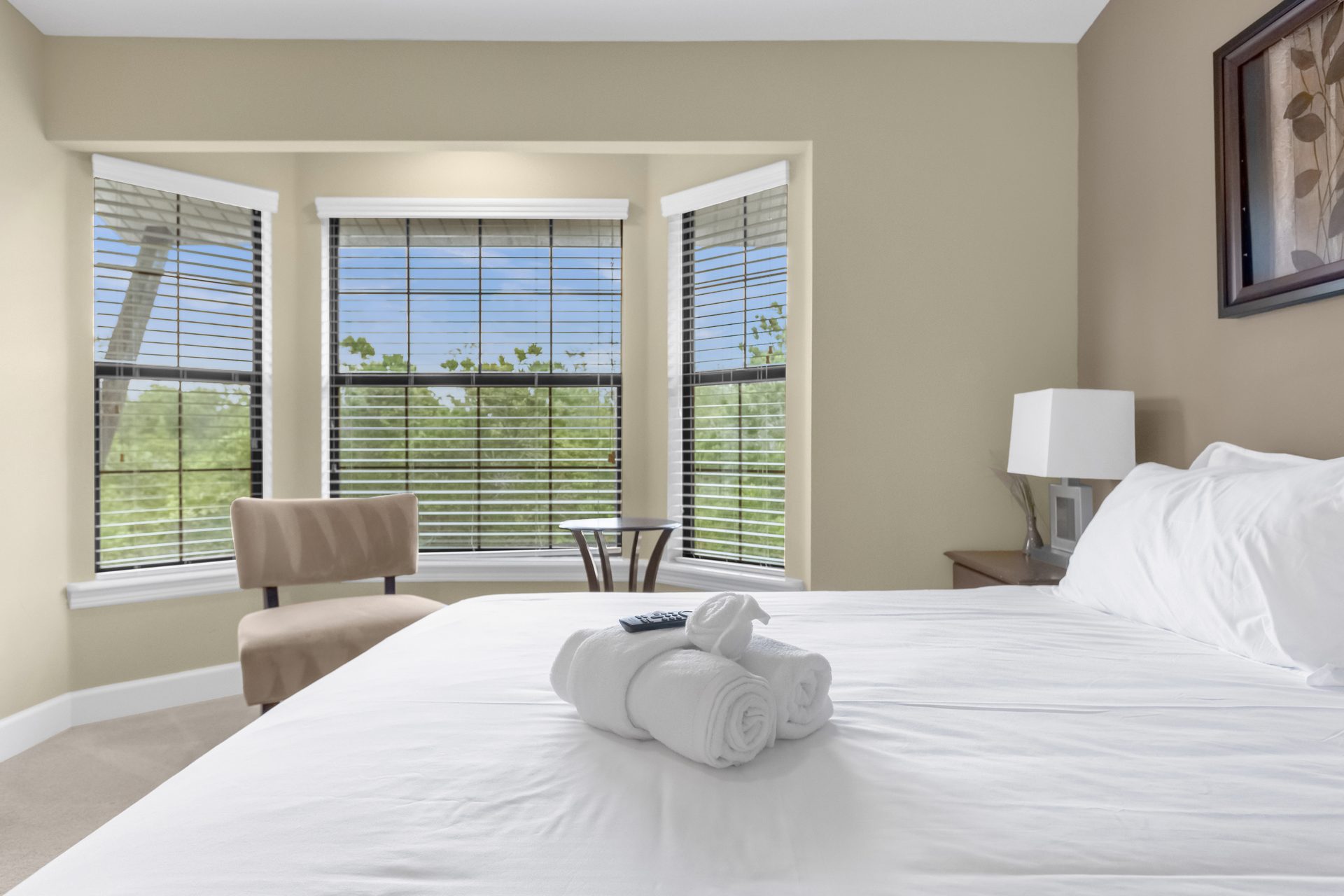 Primary bedroom with bay window and sitting chair