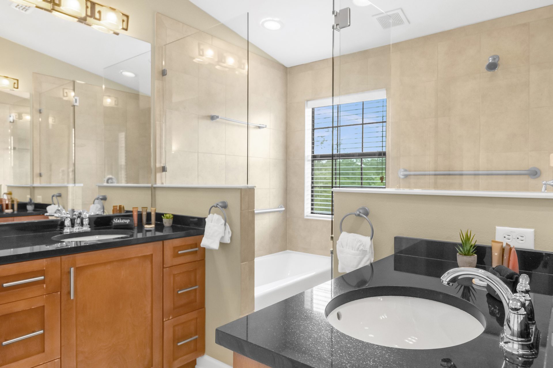 Spa-style primary bath with dual vanity and soaking tub